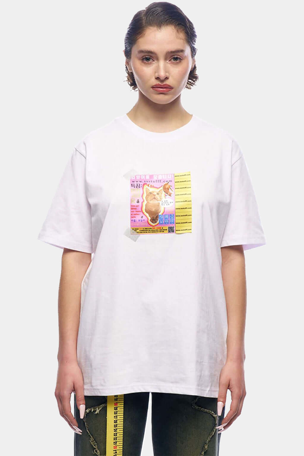 Model wearing the white Missing Cat Tee, the flyer patch visible at chest height