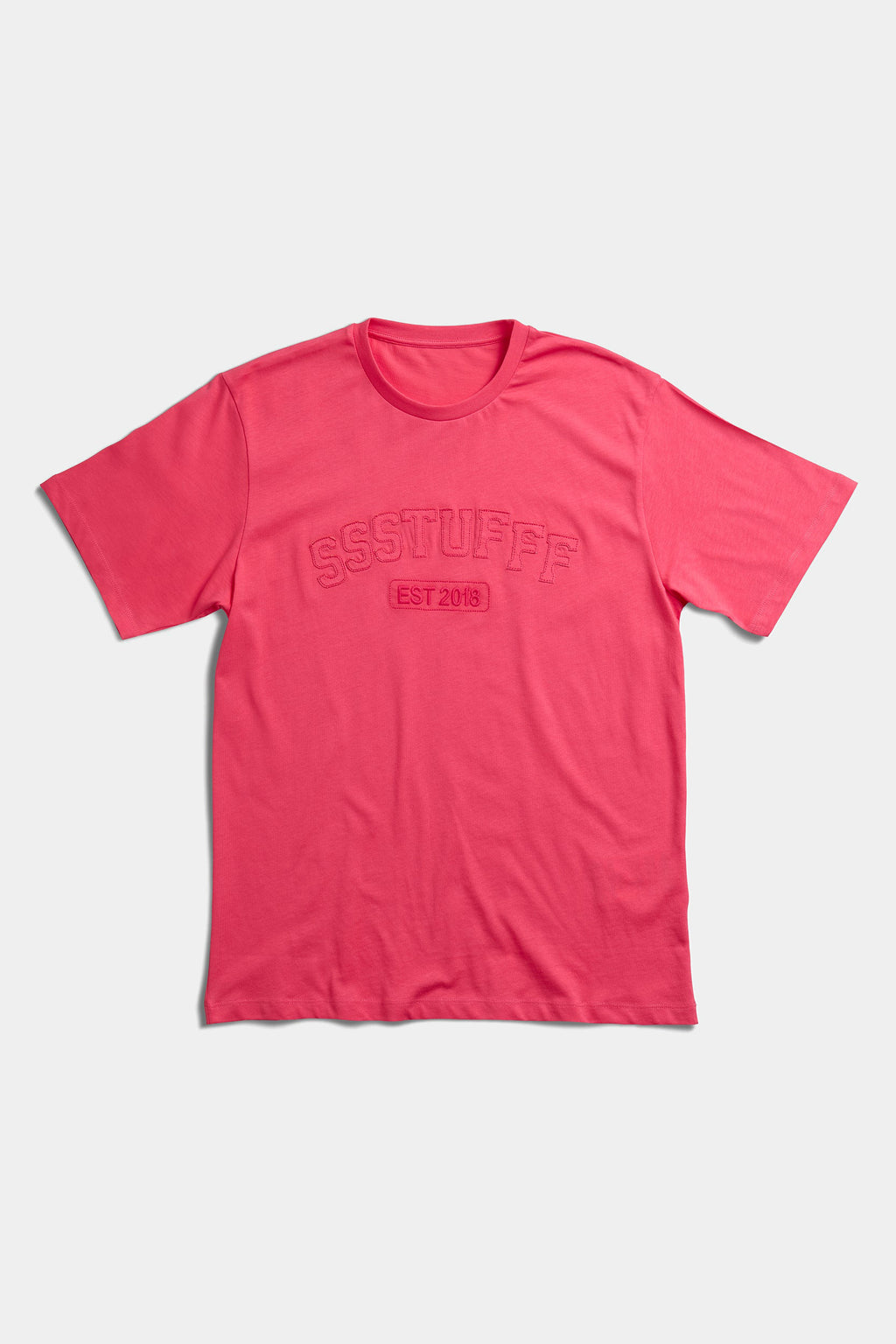 Coral red t-shirt laid flat with tonal embossed SSSTUFFF EST 2018 college lettering across the chest