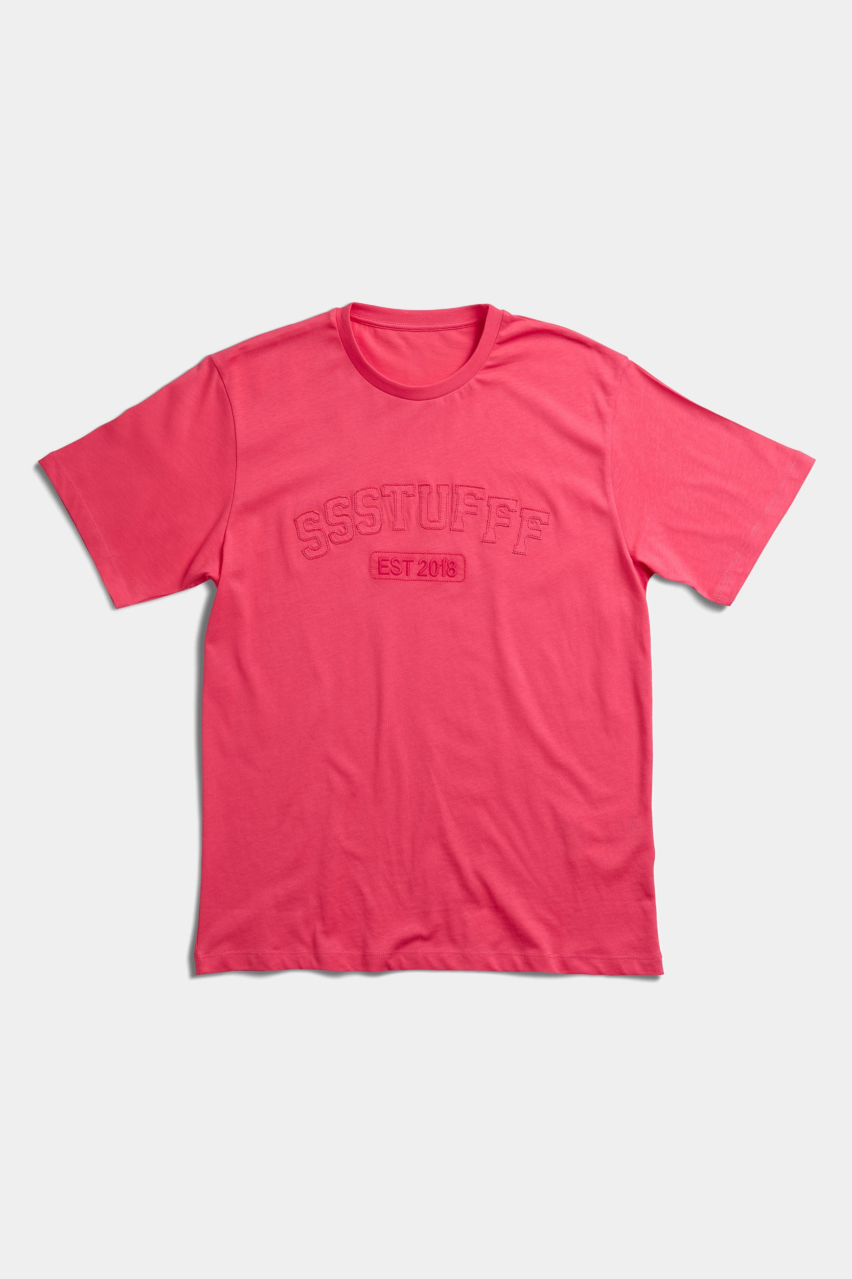 Coral red t-shirt laid flat with tonal embossed SSSTUFFF EST 2018 college lettering across the chest