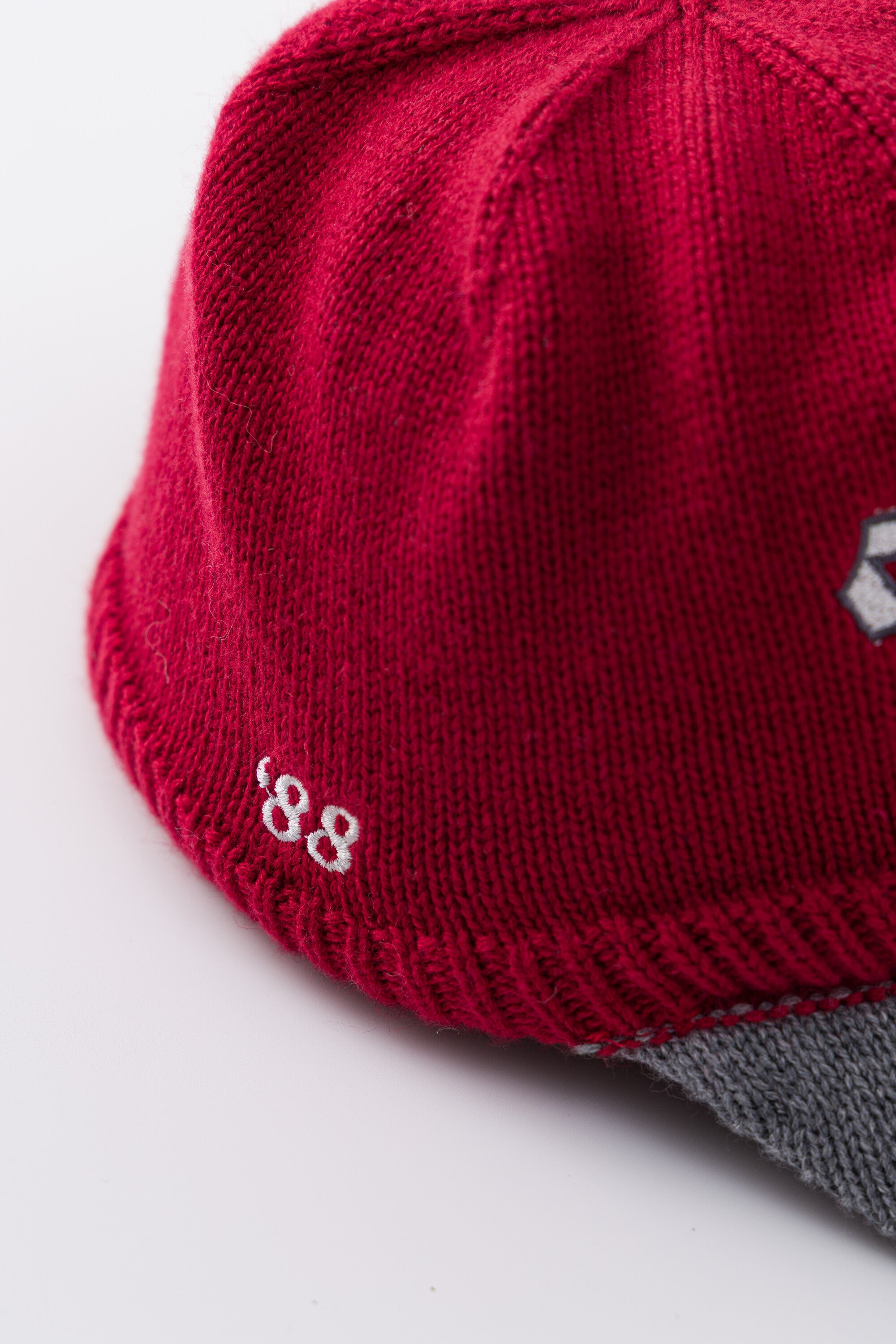 Side view of the red Knitted Cap showing the 88 embroidery and the grey brim.