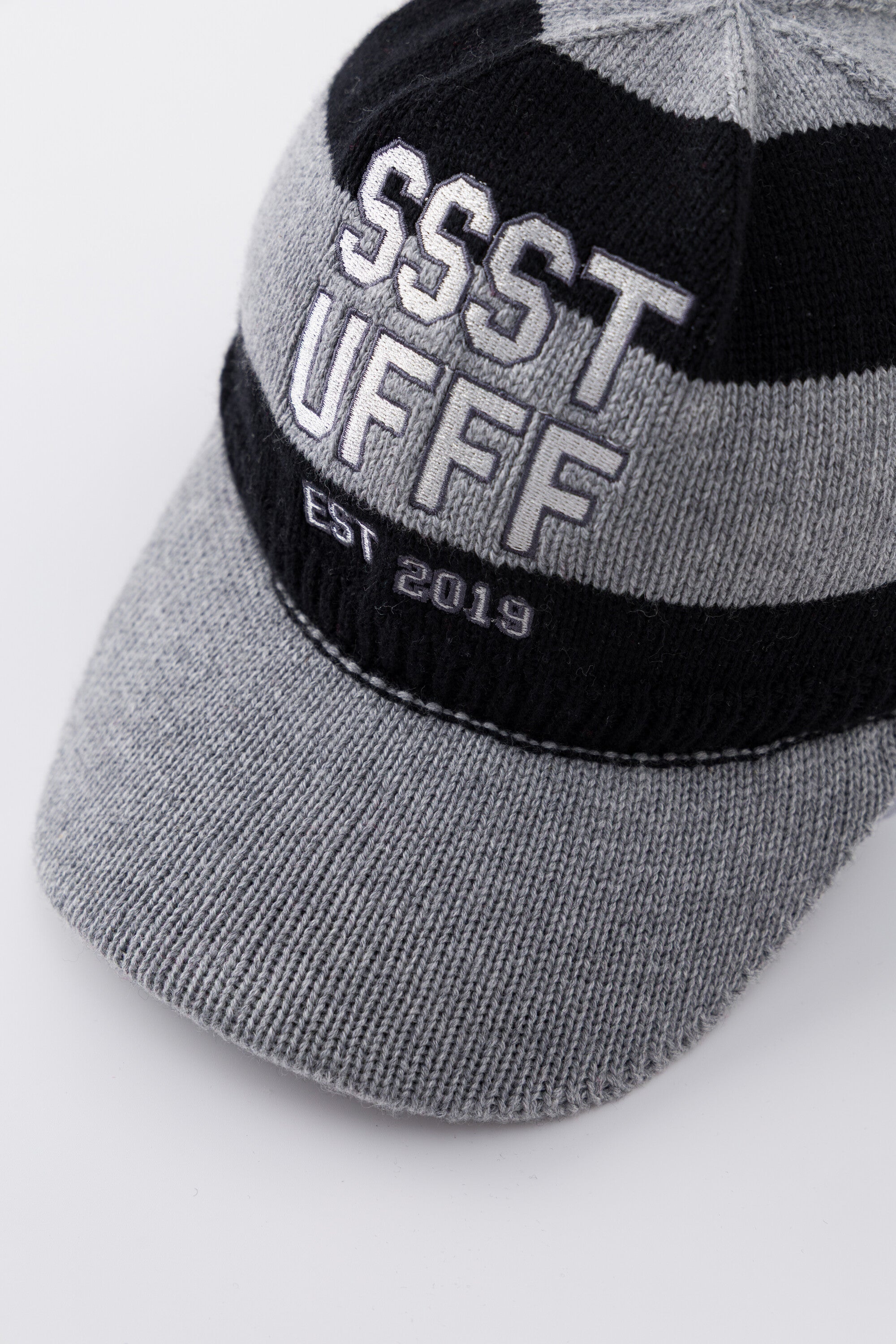 Side profile of the Striped Knitted Cap showing the ribbed knitted brim.