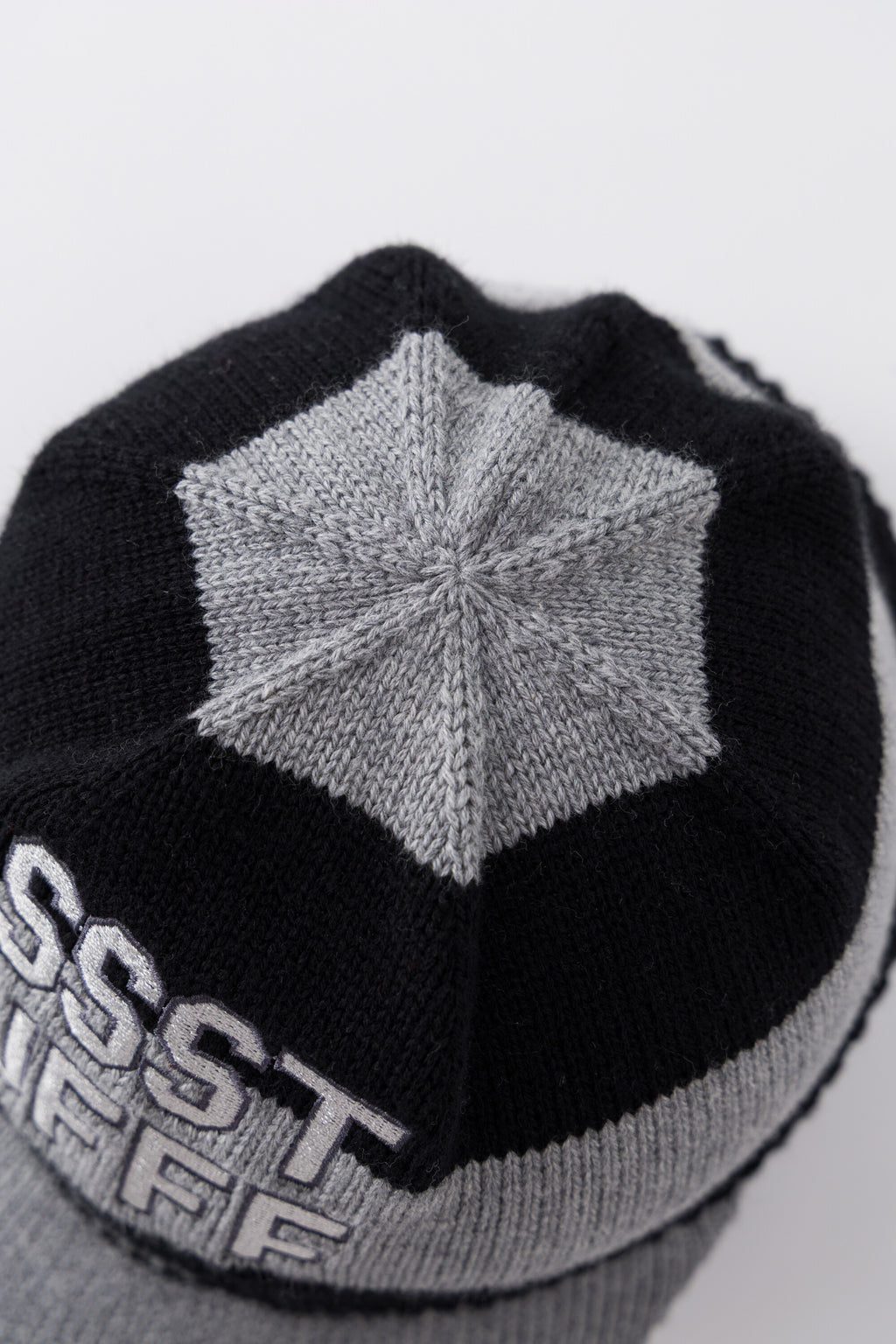 Top view of the Striped Knitted Cap showing the grey knitted star panel at the crown.