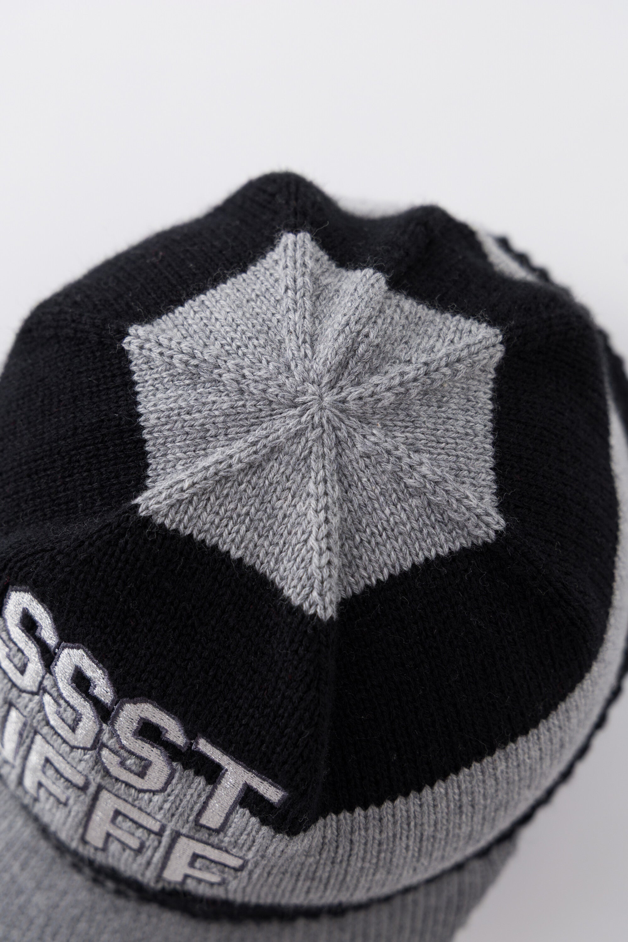 Top view of the Striped Knitted Cap showing the grey knitted star panel at the crown.